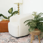 Fauteuil pivotant en tissu bouclé style Mid-century Modern